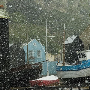 England, East Sussex, Fishing boats covered with snow in old town; Hastings