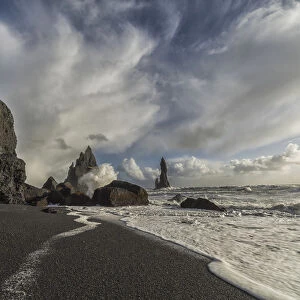 Large Waves Crash Against The Shoreline And Sea Stacks On The Southern Shore Of Iceland, Near Vik; Iceland