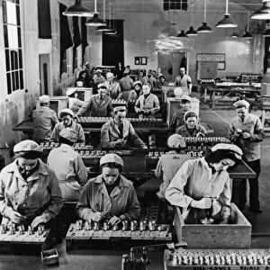 In a bright, airy shop in a Ministry of Supply factory, fuses are assembled by girls