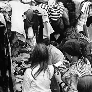 Eager shoppers rumage around one of the clothing stall in London
