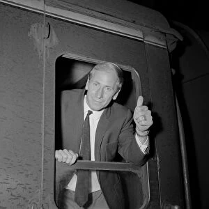 England footballer Bobby Charlton gives the thumbs up gesture as he leans out of