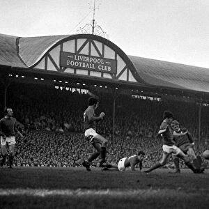 Liverpool forward Ron Yeats challenged for the ball by Manchester United defenders during