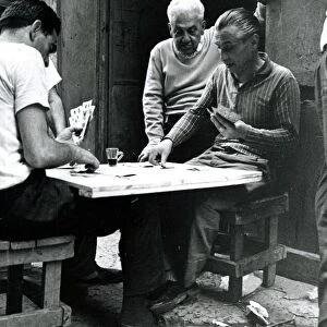 Men playing cards outdoors in Naples Italy - June 1962