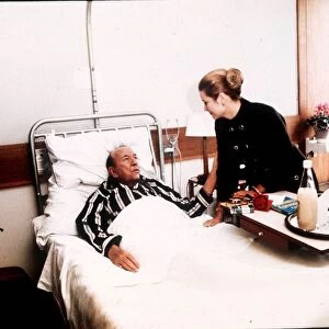 Noel Coward lying in hospital bed visited by Princess Grace of Monaco in St Thomas