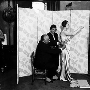 Paul Poiret designing a gown on one of his Mannequins October 1924