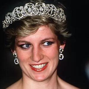 Princess Diana wearing a black dress and tiara attends at a banquet hosted by