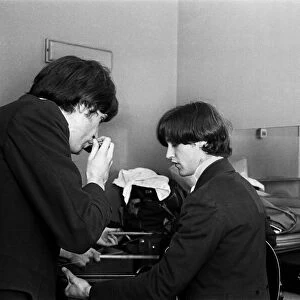 Ray Davies and Dave Davies of The Kinks pop group rehearsing in their dressing room