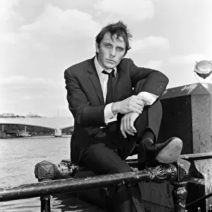 Terence Stamp actor sitting on railing beside the River Thames. 13th September 1962