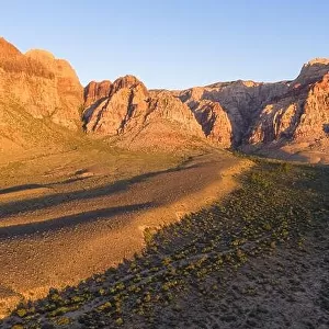 Early morning sunlight illuminates a beautiful mountain landscape that rises from the desert in Red Rock Canyon not far from Las Vegas, Nevada