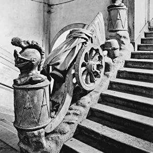 Balustrade of the stairway of Palazzo Rusca in Como, with sculptures depicting crested helmets and a wheel