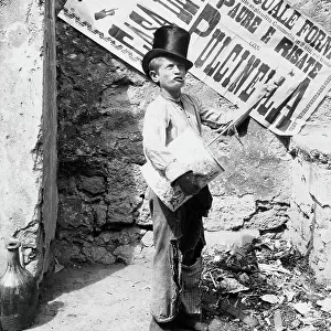Child with drum and cylinder, traditionally called "player Putaputa Caccavello", a street in Naples