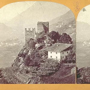 Mountain landscape near Merano (Trentino-Alto Adige). In the foreground, the ruins of the Castle of Brunnen, with a house next to it and surrounded by vegetable gardens