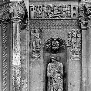 Detail of the sculpted decorations of the faade of the Cathedral of Fidenza, work by Benedetto Antlami: in a niche, the prophet Ezekiel and, at his sides, pilgrims guided by an angel