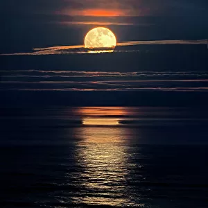 Full moon rising over the ocean