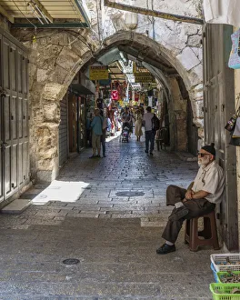 A shopkeeper minds his shop in the Old City of Jerusalem A shopkeeper minds his shop in the Old City of Jerusalem