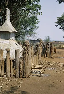 VIETNAM, Pleimrong Montagnard village graveyard with carved wooden figures on posts VIETNAM, Pleimrong Montagnard village graveyard with carved wooden figures on posts
