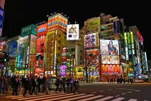 Lights of shops and buildings of Akihabara Electric Town street scene with a pedestrian crossing in Tokyo, Japan